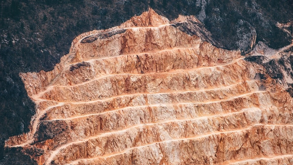 The price of copper has reached a record high of $13,000. What is driving the market upward?